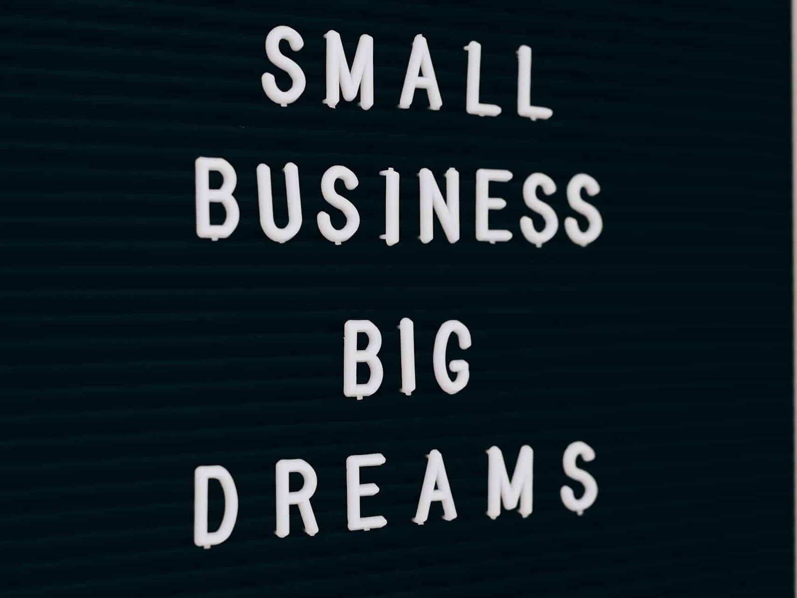 Close-up of a motivational quote about small business dreams on a letter board.